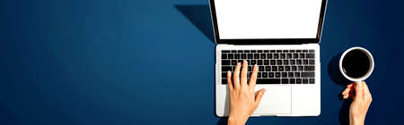 Person using a laptop computer from aboveの写真素材