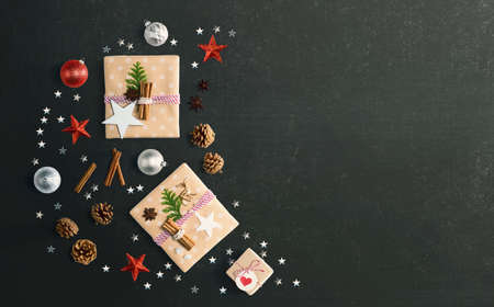 Handmade Christmas gift boxes with ornaments - flat lay