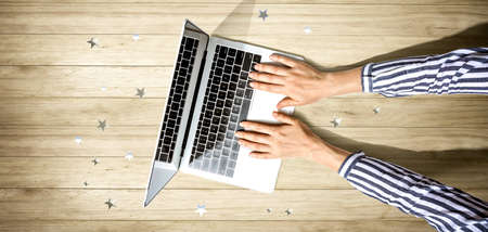 Person using a laptop computer with small stars from above