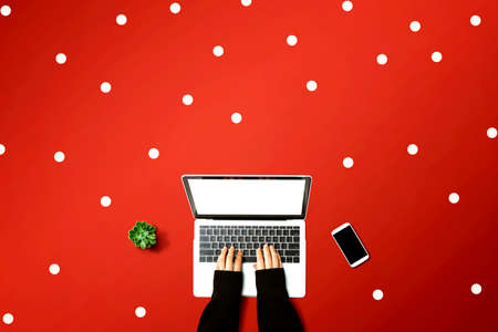 Person using a laptop computer from aboveの写真素材