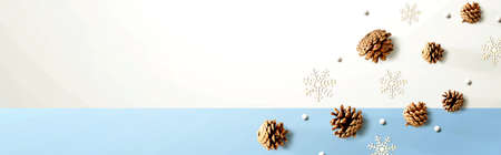 Christmas pine cones with snow flakes - flat layの写真素材