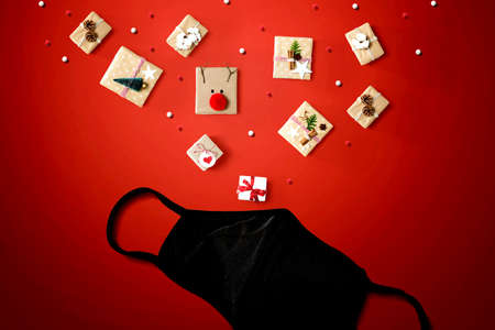 Christmas gift boxes with a cloth black face mask - flat layの写真素材