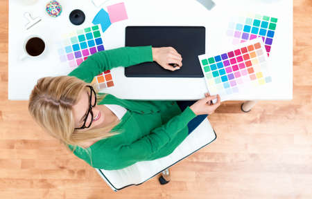Graphic designer using her graphic tablet in her home office