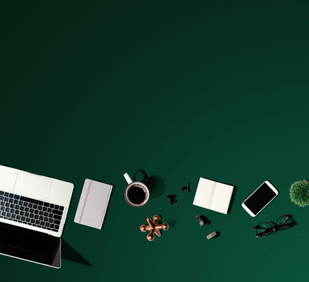 Laptop computer with office supplies - flat layの写真素材