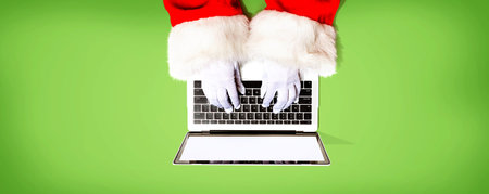 Santa Claus using a laptop computer from aboveの写真素材