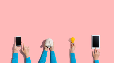 Technology devices and a piggy bank from aboveの写真素材