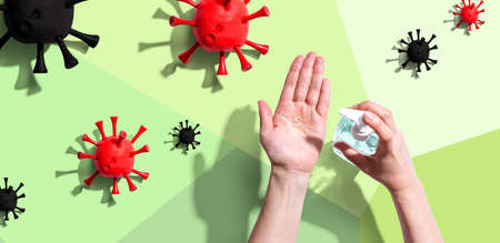 Applying sanitizer gel with viral epidemic influenza conceptの写真素材