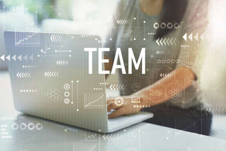 Team with woman using her laptop in her home officeの写真素材