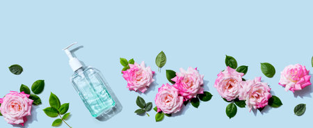 Sanitizer bottle with pink roses overhead view - flat layの写真素材