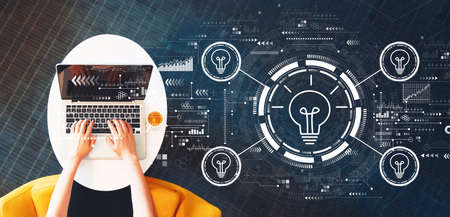Light bulbs theme with person using a laptop