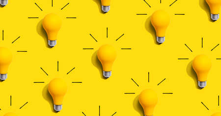 Yellow light bulb pattern with shadowの写真素材