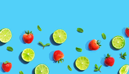 Fresh limes and strawberries with mints