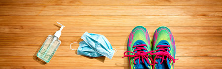 Fitness and coronavirus theme with running shoesの写真素材