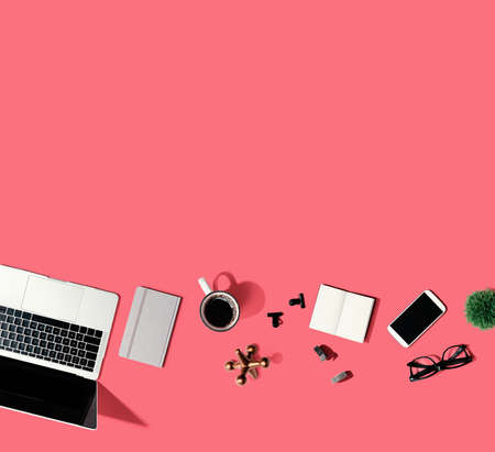 Laptop computer with office suppliesの写真素材