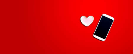 Smartphone with heart shaped dishの写真素材