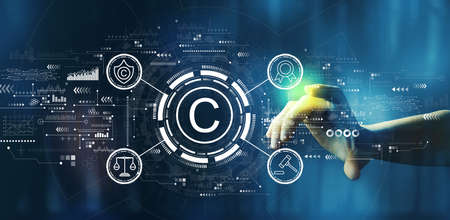 Copyright concept with hand pressing a technology screenの写真素材