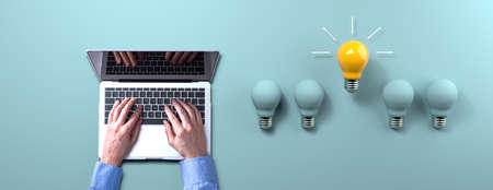 Idea light bulbs with person using a laptop computer