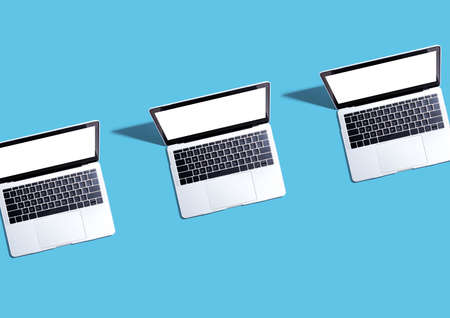 Three laptop computers with shadow