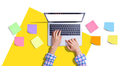 Laptop computer with many sticky notes