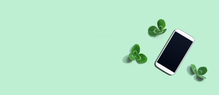 White smartphone with shamrock leaves