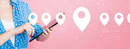 Map pin concept with woman using a tablet
