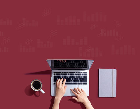 Digital graphs and hexagon grids with person using a laptopの写真素材