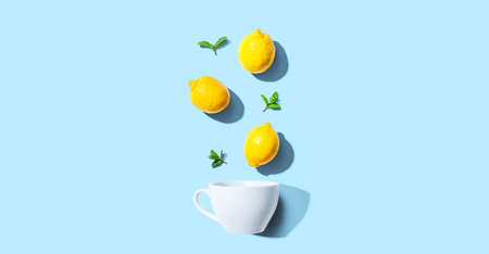 Fresh yellow lemons with tea cup overhead viewの写真素材