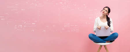 Technology screen with woman using a laptopの写真素材