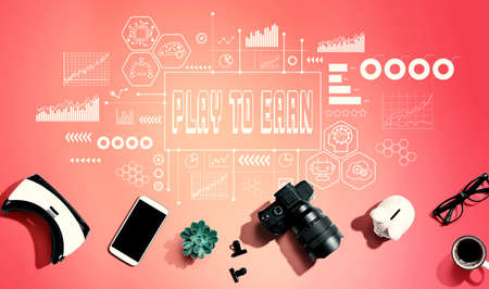 Play to Earn theme with electronic gadgets and office suppliesの写真素材