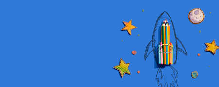 Back to school theme with a rocket and colored pencilsの写真素材