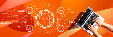 Real estate theme with person using a laptopの写真素材