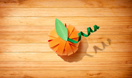 Paper craft autumn pumpkin overhead viewの写真素材