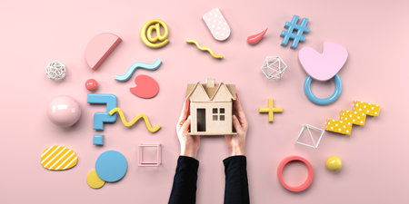 Person holding a cardboard house with geometric shapesの写真素材
