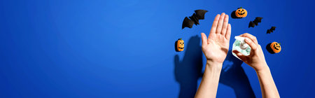 Applying sanitizer gel with Halloween themeの写真素材