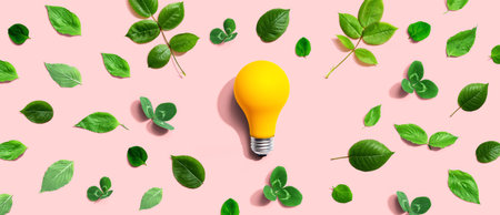 Yellow light bulb with green leavesの写真素材