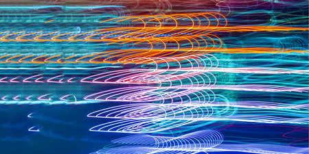 Abstract blurred bokeh neon light trails backgroundの写真素材