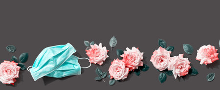 Face masks with pink roses overhead viewの写真素材