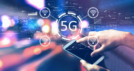 5G network with person using a smartphone at nightの写真素材