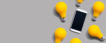 Smartphone with yellow light bulbsの写真素材