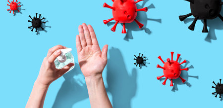 Applying sanitizer gel with epidemic influenza conceptの写真素材