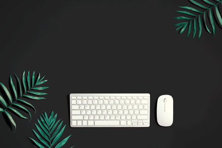 Computer keyboard and mouse with tropical plantsの写真素材