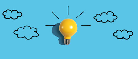 Yellow light bulb with cloud sketchesの写真素材