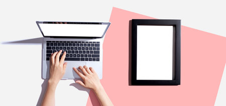 Laptop computer with a blank photo frameの写真素材