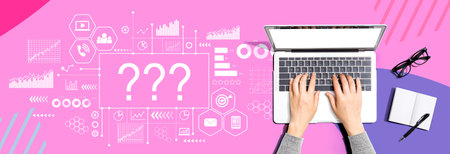 Question marks with person using a laptopの写真素材