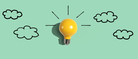Yellow light bulb with cloud sketchesの写真素材