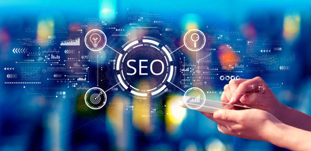 SEO concept with person using a smartphone at nightの写真素材