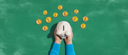 Person holding piggy bank with hand drawn coinsの写真素材
