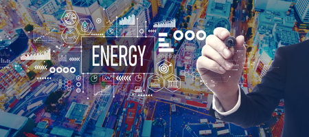 Energy theme with businessman in city at nightの写真素材
