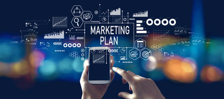Marketing plan theme with person using a smartphone at nightの写真素材