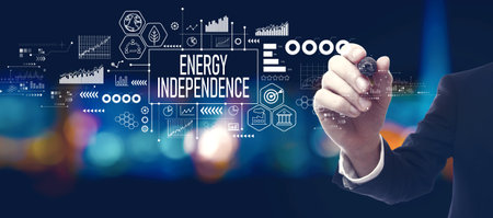 Energy Independence concept with businessman at nightの写真素材